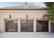 Spacious three-car garage with custom doors and exterior lighting for added security and curb appeal at 3871 Trickum Road Ne, Marietta, GA 30066