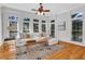Cozy living room features a plush white sectional sofa, large windows, and a stylish rug on hardwood floors at 3871 Trickum Road Ne, Marietta, GA 30066