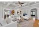 Bright living room showcasing white sofas, an archway, hardwood floors, and coffered ceilings, blending style and comfort at 3871 Trickum Road Ne, Marietta, GA 30066