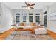 Bright living room with a comfortable white sofa, large windows offering natural light, and elegant decor at 3871 Trickum Road Ne, Marietta, GA 30066