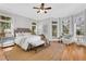 Bright and airy bedroom with large windows, hardwood floors, and a comfortable seating area at 3871 Trickum Road Ne, Marietta, GA 30066