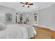 Spacious main bedroom featuring a plush bed, large windows, and hardwood floors at 3871 Trickum Road Ne, Marietta, GA 30066
