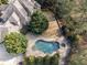 A pristine swimming pool with a spa is nestled in a private backyard oasis surrounded by lush greenery at 3871 Trickum Road Ne, Marietta, GA 30066