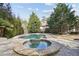 Luxurious backyard with a pool and hot tub surrounded by lush landscaping, creating a private retreat at 3871 Trickum Road Ne, Marietta, GA 30066