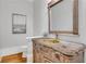 Stylish powder room with an ornate vanity, vessel sink, and decorative mirror at 3871 Trickum Road Ne, Marietta, GA 30066