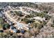 Aerial view of a residential neighborhood showcasing homes nestled among trees with a winding road system at 201 Chert Way, Atlanta, GA 30349
