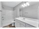 Bathroom featuring tub/shower combination and single sink vanity with modern lighting at 201 Chert Way, Atlanta, GA 30349