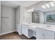 Bathroom featuring double sink vanity, large mirror, and modern lighting at 201 Chert Way, Atlanta, GA 30349