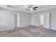 Large primary bedroom with tray ceiling and neutral carpet, leading to ensuite and closet at 201 Chert Way, Atlanta, GA 30349