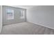 Spacious bedroom featuring neutral paint, plush carpet, and bright windows at 201 Chert Way, Atlanta, GA 30349