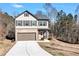 Charming two-story home featuring a brick and vinyl facade, attached garage, and well-manicured lawn at 201 Chert Way, Atlanta, GA 30349