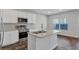 Modern kitchen island features granite countertops, stainless steel appliances, and classic white cabinets at 201 Chert Way, Atlanta, GA 30349