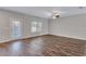 Spacious living area features hardwood floors, neutral paint, and a glass door leading to the outdoors at 201 Chert Way, Atlanta, GA 30349