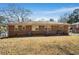 Home's back exterior showing a simple brick facade and ample backyard space, ideal for outdoor living at 2631 Miriam Ln, Decatur, GA 30032