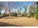 Expansive backyard features a large grassy area, mature trees, and a classic wooden fence at 2631 Miriam Ln, Decatur, GA 30032