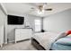 A cozy bedroom features a ceiling fan, dresser and a wall-mounted television at 4119 Ravenwood Ct, Union City, GA 30291