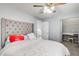 This bedroom has a tufted headboard, ceiling fan, and an attached study area at 4119 Ravenwood Ct, Union City, GA 30291