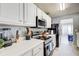 Functional kitchen with white cabinets, stainless steel appliances, and ample counter space at 4119 Ravenwood Ct, Union City, GA 30291