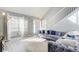 Sun-filled living room featuring a vaulted ceiling, white railing, and stylish gray sofa at 4119 Ravenwood Ct, Union City, GA 30291