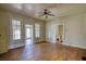 View of the living room featuring hardwood floors, multiple windows and a ceiling fan at 4398 Highway 142, Newborn, GA 30056