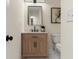 Bathroom featuring a single sink vanity, square mirror, and neutral paint at 6974 Clearlake Ct, Peachtree Corners, GA 30360