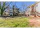 A partial backyard view showing part of the house, fence and grass yard space at 1046 Katherwood Sw Dr, Atlanta, GA 30310