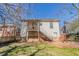 View of the backyard, featuring a small deck, metal stairs, wood fence, and grassy area at 1046 Katherwood Sw Dr, Atlanta, GA 30310