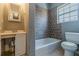 Bathroom with a tub and toilet beneath a window at 1046 Katherwood Sw Dr, Atlanta, GA 30310