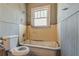 Bathroom featuring a tub, toilet and a window at 1046 Katherwood Sw Dr, Atlanta, GA 30310