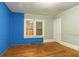 Bedroom featuring a combination of gray and blue walls and wood floors at 1046 Katherwood Sw Dr, Atlanta, GA 30310