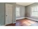 Bedroom featuring hard wood flooring and two windows at 1046 Katherwood Sw Dr, Atlanta, GA 30310