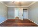 Bedroom with wood flooring, a ceiling fan, closet, and entry door at 1046 Katherwood Sw Dr, Atlanta, GA 30310