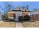 Exterior shot of boarded house with small yard and brick foundation and chimney at 1046 Katherwood Sw Dr, Atlanta, GA 30310