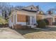 Exterior shot of boarded house with small yard and brick foundation and chimney at 1046 Katherwood Sw Dr, Atlanta, GA 30310