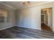 Renovated room with gray walls, light trim, new gray vinyl floor, and window at 1046 Katherwood Sw Dr, Atlanta, GA 30310