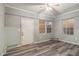 Room with gray walls, new gray vinyl floor, and boarded windows with bare trim at 1046 Katherwood Sw Dr, Atlanta, GA 30310