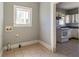 Room with washer/dryer hookups leading into kitchen at 1046 Katherwood Sw Dr, Atlanta, GA 30310