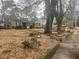 Charming single-Gathering home featuring a manicured lawn and mature trees on an overcast day at 1779 South Gordon Sw St, Atlanta, GA 30310