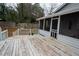 A spacious back deck is shown with a railing and a screened-in porch attached to the house at 3981 Rocmar Dr, Snellville, GA 30039