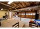 Unfinished basement with exposed ceiling, concrete floor, and open garage door at 3981 Rocmar Dr, Snellville, GA 30039