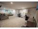 Spacious finished basement with carpet flooring, office area, and a comfortable sectional sofa at 3981 Rocmar Dr, Snellville, GA 30039