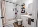 Updated bathroom featuring tiled shower with decorative curtain and modern fixtures at 3981 Rocmar Dr, Snellville, GA 30039