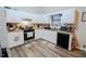 Well-lit kitchen featuring white cabinetry, granite countertops, and modern appliances at 3981 Rocmar Dr, Snellville, GA 30039