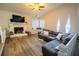 Inviting living room featuring a fireplace, large sectional sofa, and a cozy window seat at 3981 Rocmar Dr, Snellville, GA 30039