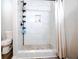 Stylish shower with floor-to-ceiling white tiles, a built-in niche, and a pebble-stone shower floor at 3981 Rocmar Dr, Snellville, GA 30039