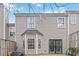 View of the backyard that features a small concrete patio, gray siding, and mature trees at 6374 Rockaway Rd, Atlanta, GA 30349