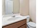 This bathroom features a vanity with a sink, a toilet, and a framed mirror at 6374 Rockaway Rd, Atlanta, GA 30349