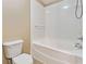 A clean white bathroom features a bathtub with white tile surround at 6374 Rockaway Rd, Atlanta, GA 30349