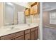 The bathroom features double sinks, wood cabinetry, and a large mirror at 6374 Rockaway Rd, Atlanta, GA 30349