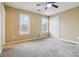 The bedroom is equipped with a ceiling fan and has abundant natural light from its two large windows at 6374 Rockaway Rd, Atlanta, GA 30349